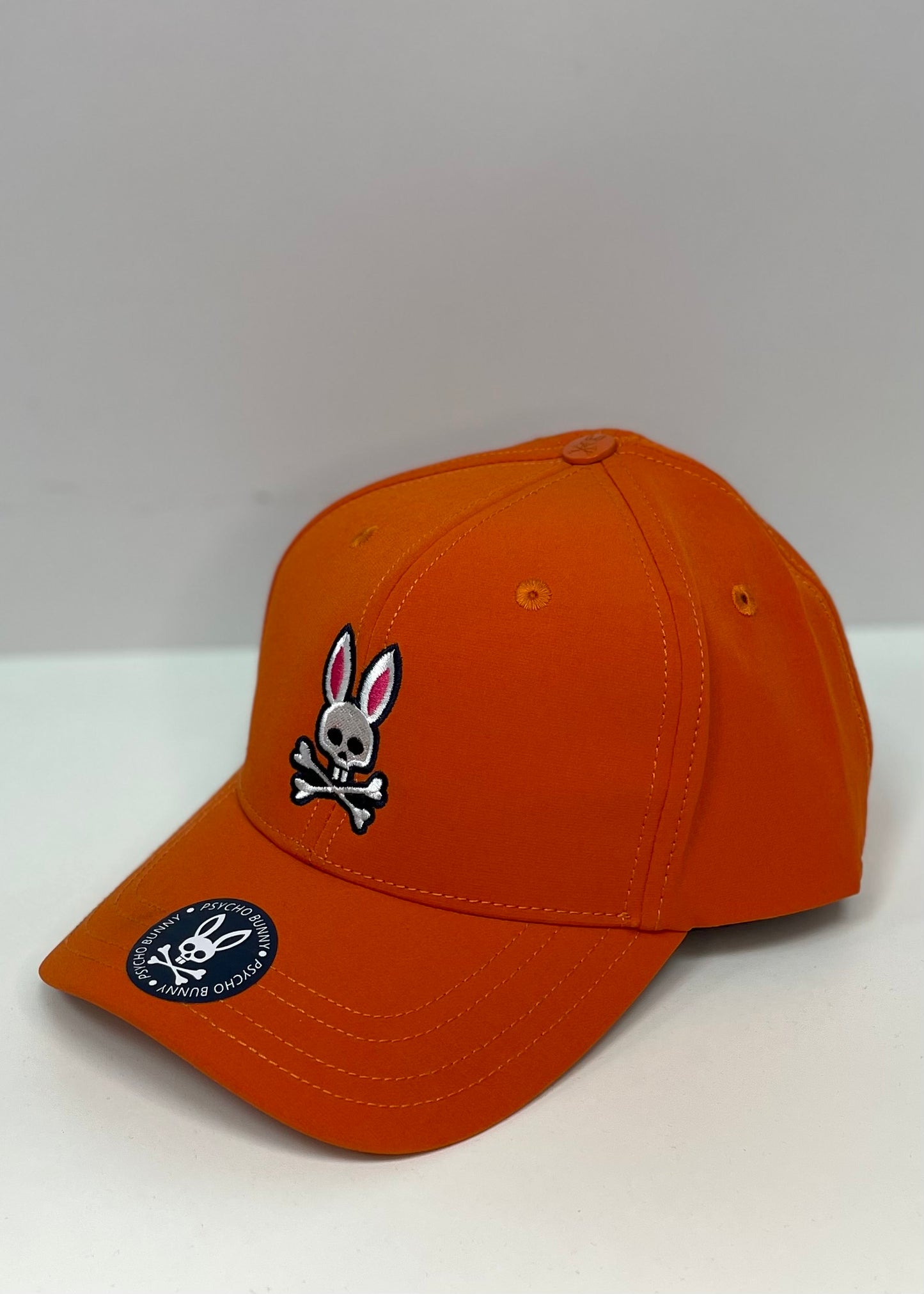 Gorra Psycho Bunny  🐰 color naranja intenso con logotipo multicolor