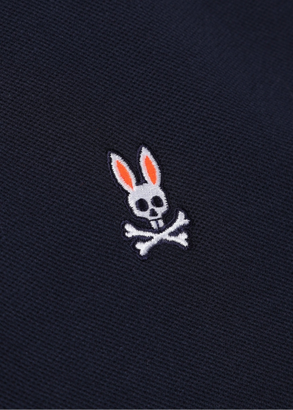 Camiseta Polo Psycho Bunny 🐰 Pique en color azul navy con diseño de cuello en rojo y lila Talla L Entalle Regular