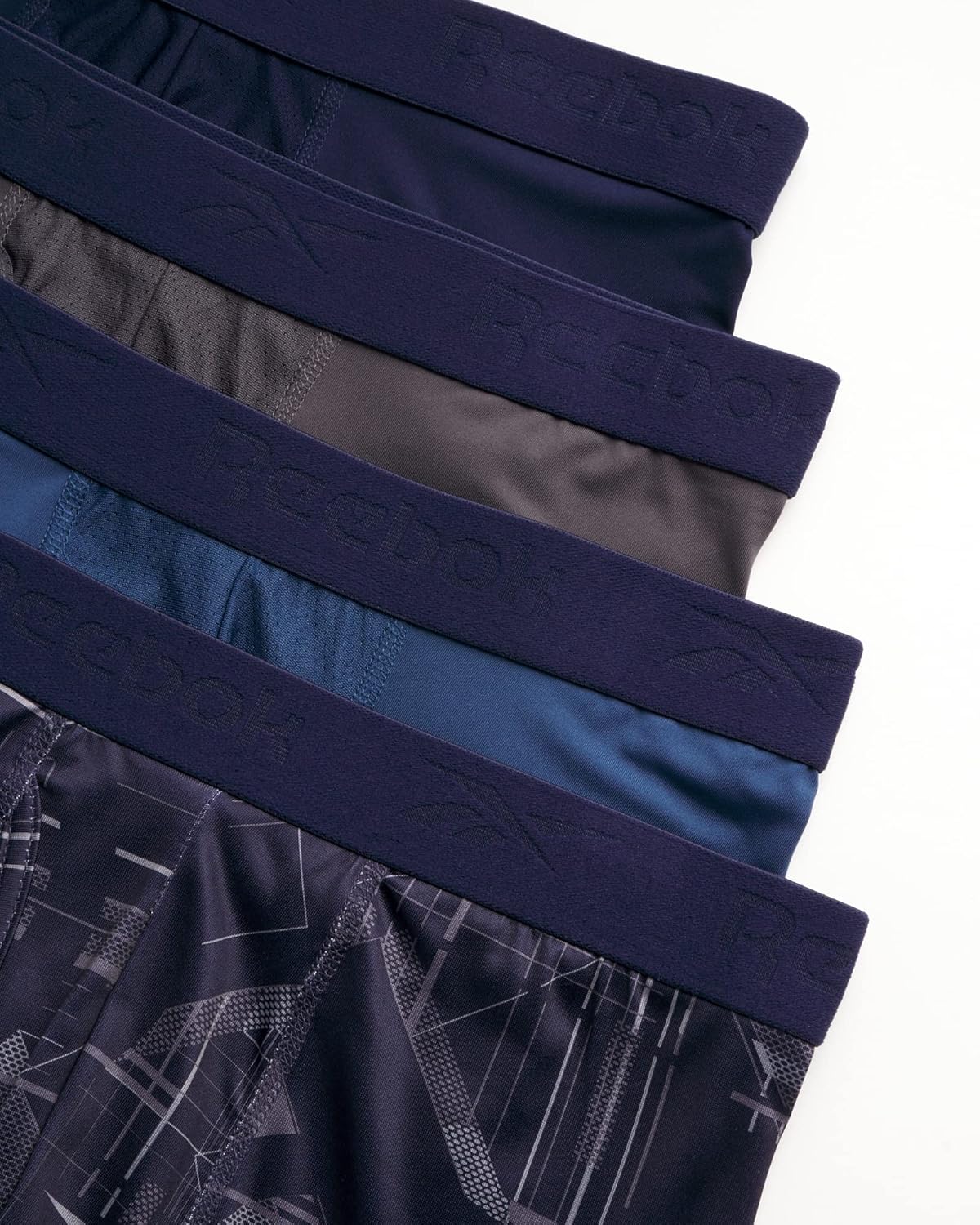 Combo de 4 Boxers Briefs Reebok Tela Performance en color gris, azul, azul navy y estampado Talla M