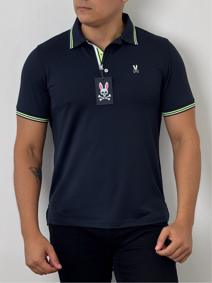 Camiseta Polo Psycho Bunny 🐰 Dry-fit en color azul navy con diseño de cuello en verde y blanco Talla M Entalle Regular
