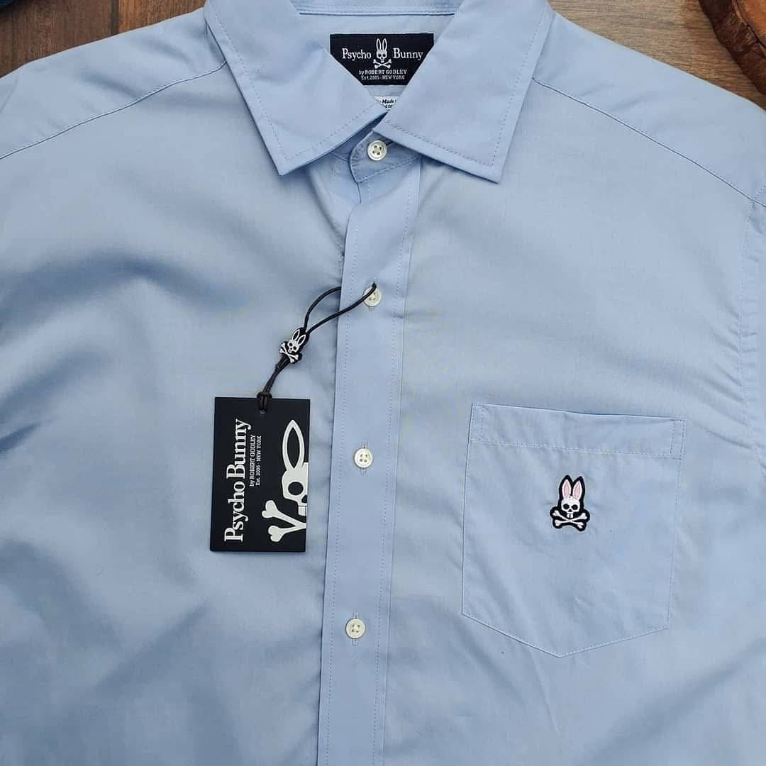 Camisa de botones Psycho Bunny 🐰  Color celeste claro con logo tradicional Talla L Entalle Regular