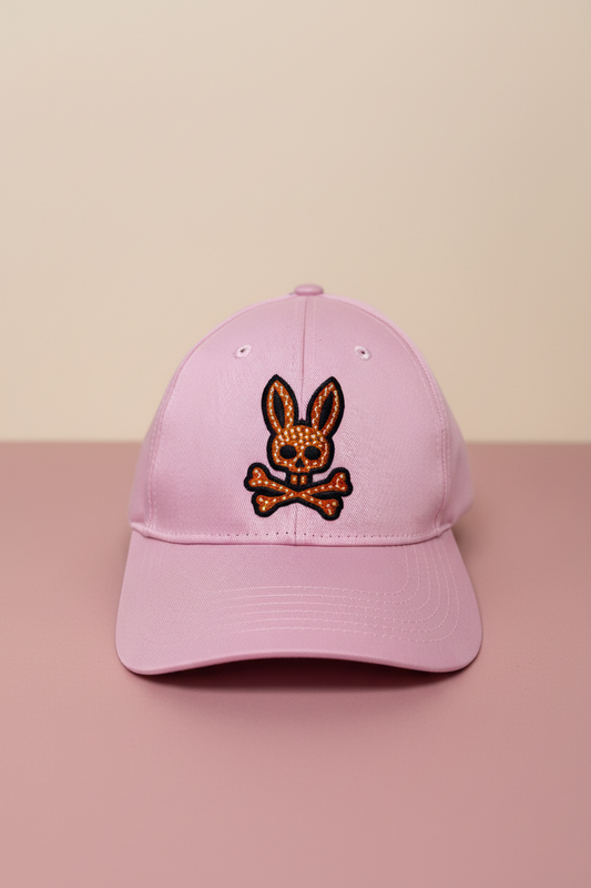 Gorra Psycho Bunny  🐰 color rosado claro con logotipo bordado en negro y naranja