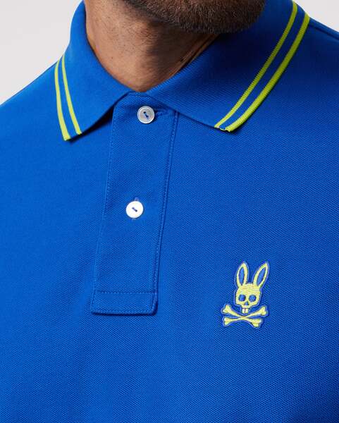 Camiseta Polo Psycho Bunny 🐰 Pique en color azul con diseño de cuello en verde intenso Talla S Entalle Regular