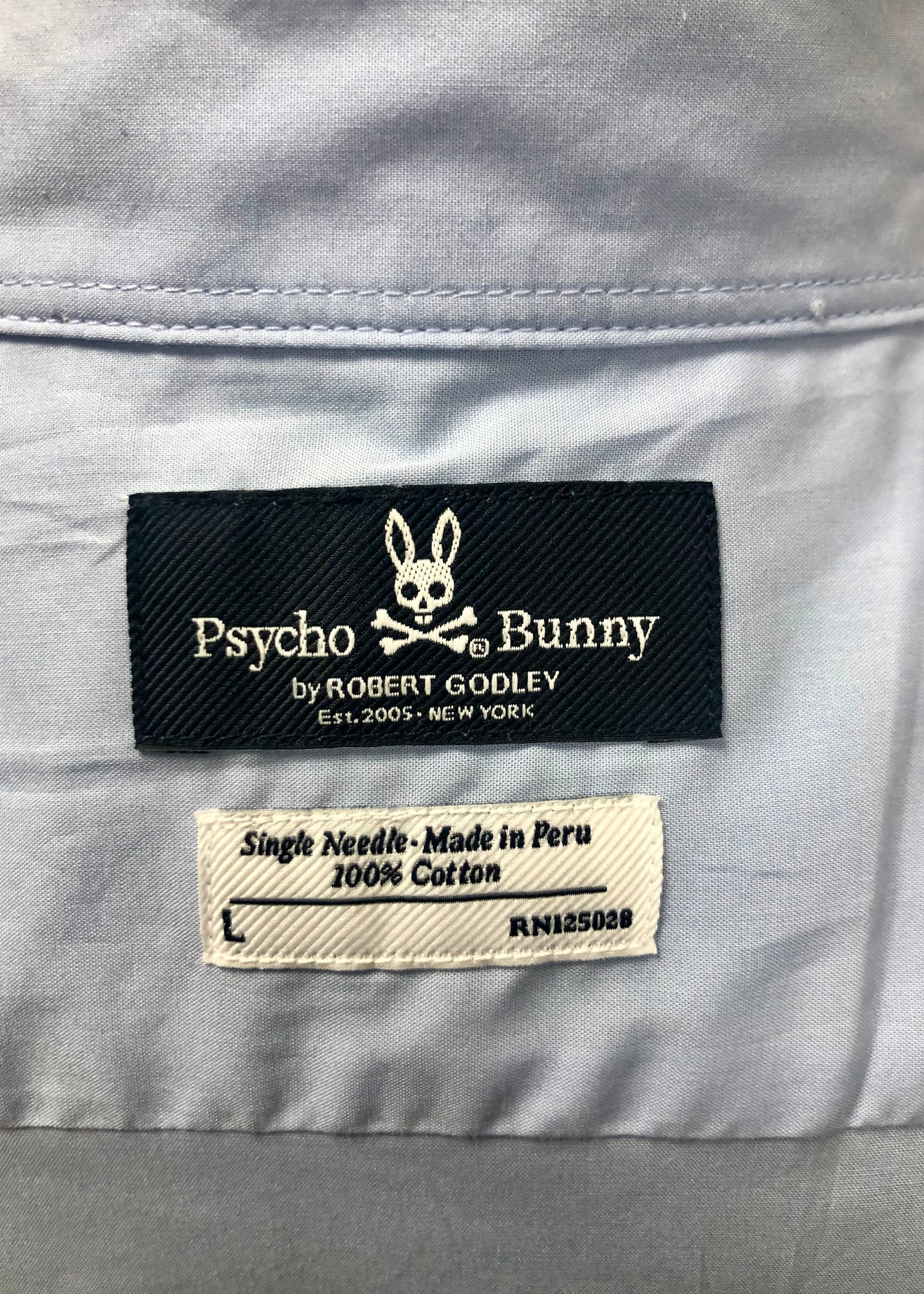 Camisa de botones Psycho Bunny 🐰  Color celeste claro con logo tradicional Talla L Entalle Regular