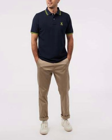 Camiseta Polo Psycho Bunny 🐰 Pique en color azul navy con diseño de cuello en verde intenso Talla M Entalle Regular