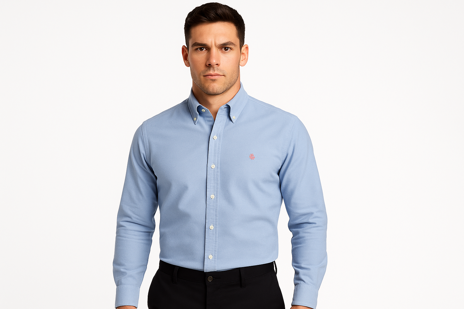 Athletic model wearing light blue shirt with button-down collar and crest logo
