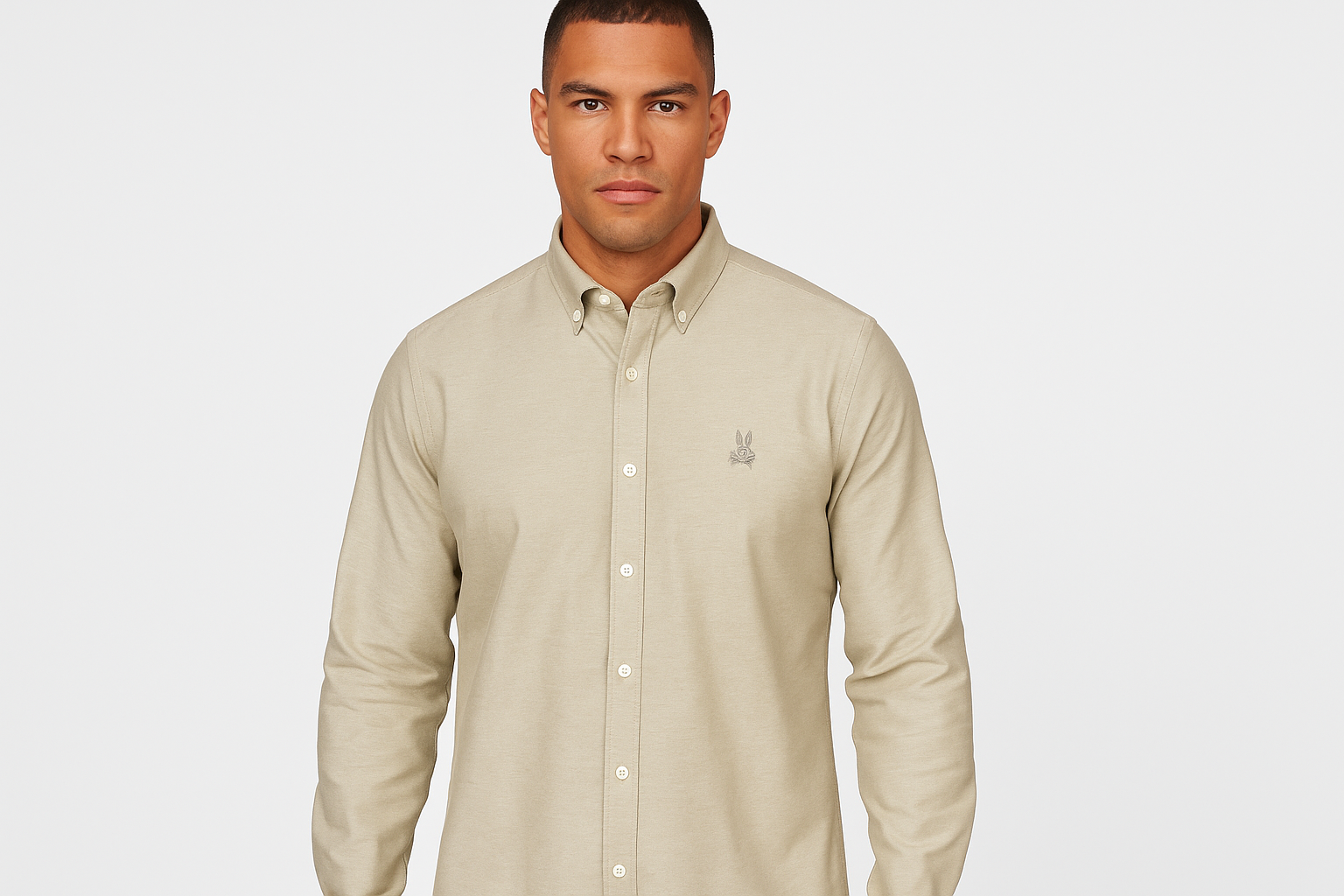 Modelo atlético Psycho Bunny Oxford kaki claro logo gris frontal